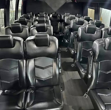 Clean black minibus interior with comfortable passenger seating