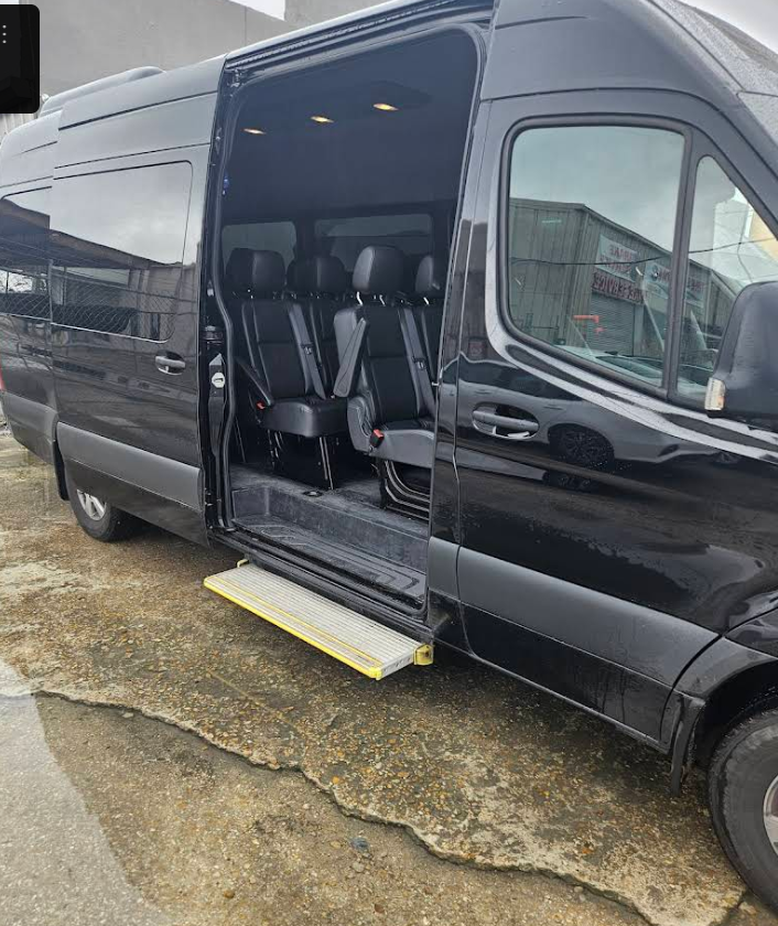 Black Mercedes Sprinter minibus with passenger step open